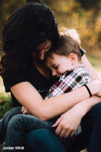 mom holding young son